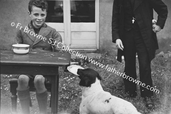 BOY PLAYING WITH DOG